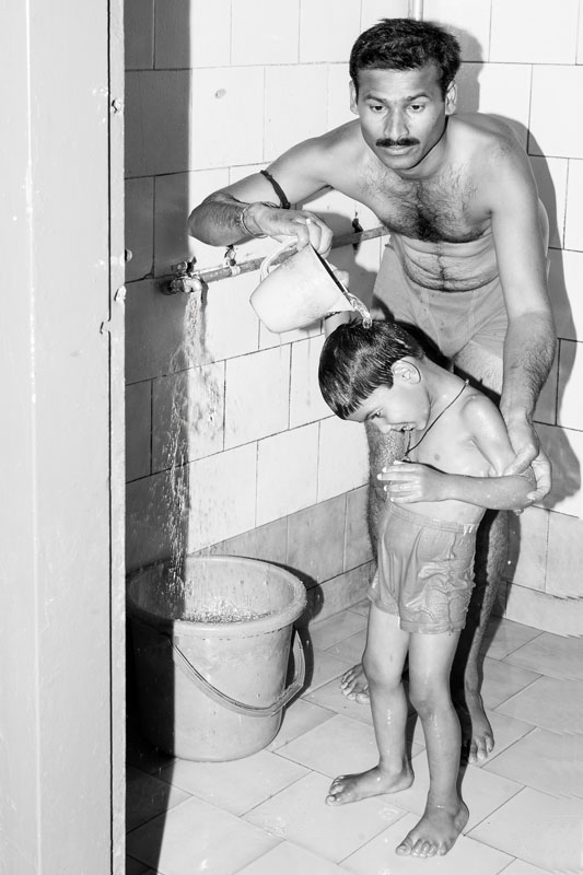 Men and Water Needs from Gender Perspective - Helping young son bathe in Ahmednagar district, Maharashtra